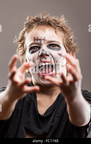 Screaming walking dead zombie child boy Stock Photo