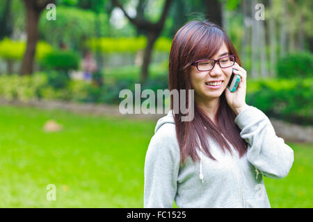 Young business woman with mobile phone in leisure time Stock Photo
