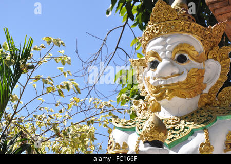 Golden and white statue of a guardian, Wat Saen Muang Mai Luang, Buddhist temple, Chiang Mai, Thailand Stock Photo