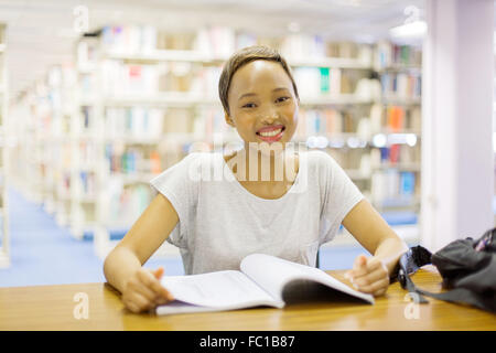 portrait of happy young female African college student in library Stock Photo