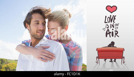 Composite image of smiling couple standing outside together Stock Photo