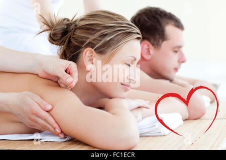 Composite image of loving couple having an acupunctre therapy Stock Photo