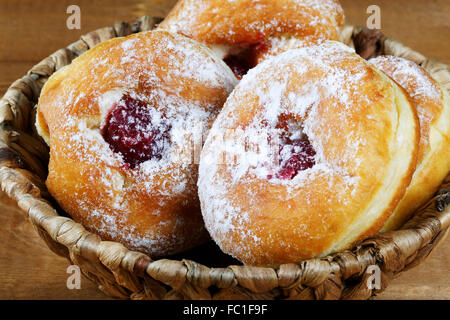 donuts with jam in a wicker basket Stock Photo