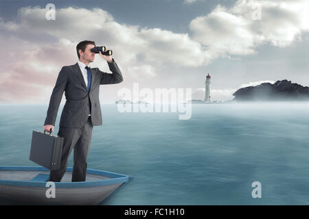 Composite image of businessman in boat with binoculars Stock Photo