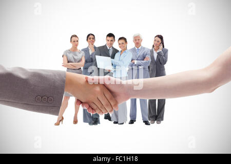 Composite image of handshake between two women Stock Photo