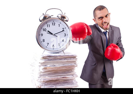 Angry businessman hitting clock isolated on white Stock Photo