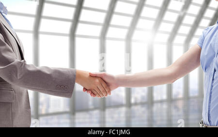 Composite image of handshake between two women Stock Photo