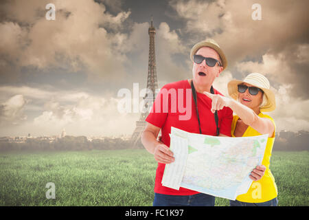 Composite image of happy tourist couple using map Stock Photo