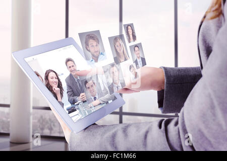 Composite image of businesswoman using a tablet pc Stock Photo