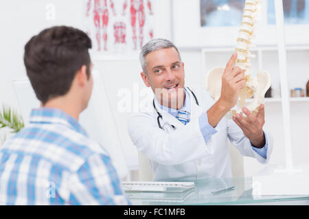 Doctor explaining anatomical spine to his patient Stock Photo