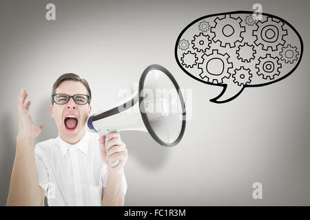 Composite image of geeky businessman shouting through megaphone Stock Photo