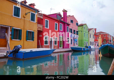 BURANO, ITALY - NOVEMBER 23: Brightly painted houses at the Burano canal on November 23, 2015 in Burano, Venice, Italy. Stock Photo