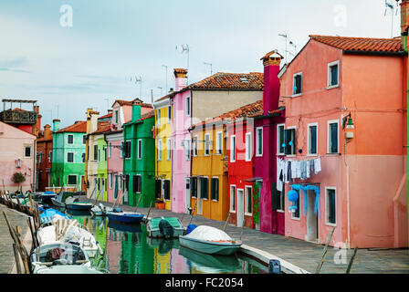 BURANO, ITALY - NOVEMBER 23: Brightly painted houses at the Burano canal on November 23, 2015 in Burano, Venice, Italy. Stock Photo