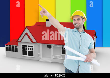 Composite image of male architect with blueprints pointing away Stock Photo