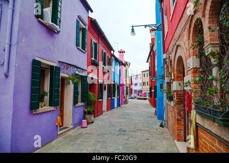 BURANO, ITALY - NOVEMBER 23: Brightly painted houses at the Burano canal on November 23, 2015 in Burano, Venice, Italy. Stock Photo