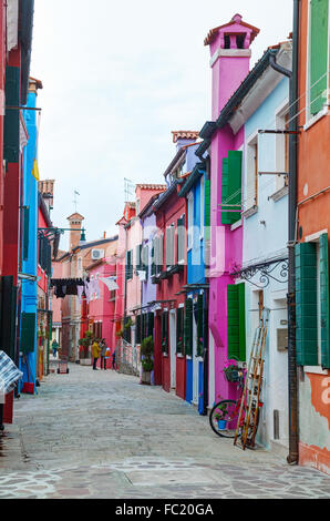 BURANO, ITALY - NOVEMBER 23: Brightly painted houses at the Burano canal on November 23, 2015 in Burano, Venice, Italy. Stock Photo