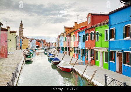 BURANO, ITALY - NOVEMBER 23: Brightly painted houses at the Burano canal on November 23, 2015 in Burano, Venice, Italy. Stock Photo