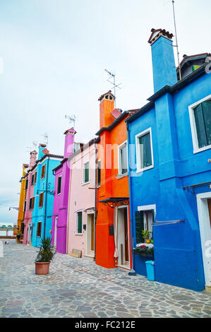 BURANO, ITALY - NOVEMBER 23: Brightly painted houses at the Burano canal on November 23, 2015 in Burano, Venice, Italy. Stock Photo