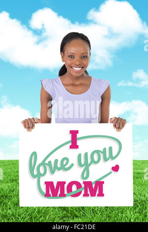 Composite image of woman with placeholder in her hands on white background Stock Photo