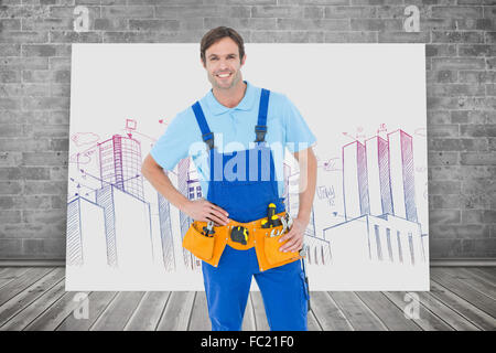 Composite image of confident carpenter with hands on hip Stock Photo