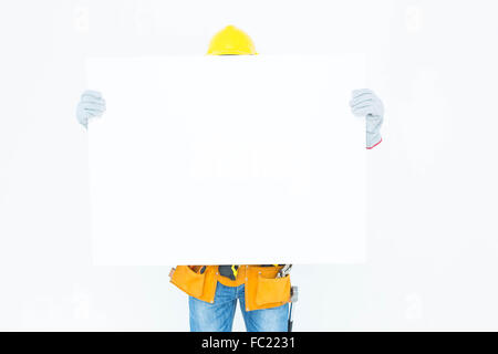 Architect with bill board over white background Stock Photo