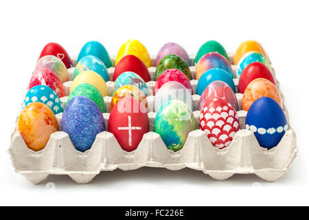 Full tray with colored and ornate Easter eggs isolated on white background. Stock Photo