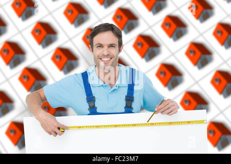 Composite image of happy carpenter measuring blank bill board Stock Photo