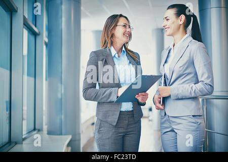 Two cheerful businesswomen discussing plans Stock Photo