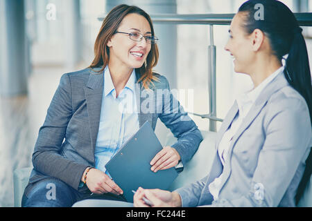 Two businesswomen discussing their ideas at break Stock Photo