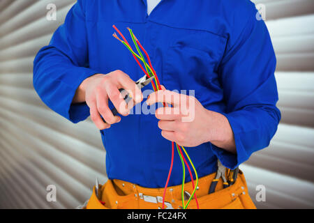 Composite image of electrician cutting wire with pliers Stock Photo