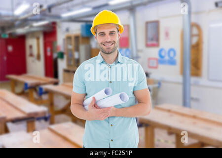 Composite image of happy male architect holding blueprints Stock Photo
