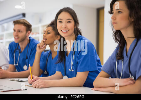 Medical student smiling at the camera during class Stock Photo