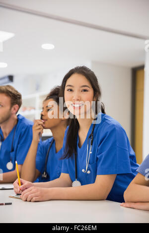 Medical student smiling at the camera during class Stock Photo