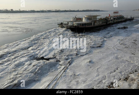 Dandong. 20th Jan, 2016. Photo taken on Jan. 20, 2016 shows the boats near the Yalu River Broken Bridge trapped by thick ice in Dandong, northeast China's Liaoning Province. Continuous chilling weather brought serious freeze-up to the Yalu River. Credit:  Qi Wanpeng/Xinhua/Alamy Live News Stock Photo
