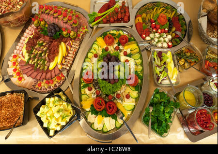 Table with sausage and cheese plate, antipasti, dips and salads Stock Photo