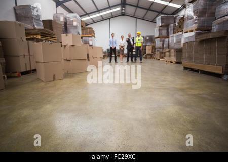 Warehouse managers and worker talking together Stock Photo