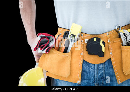 Composite image of technician with tool belt around waist Stock Photo