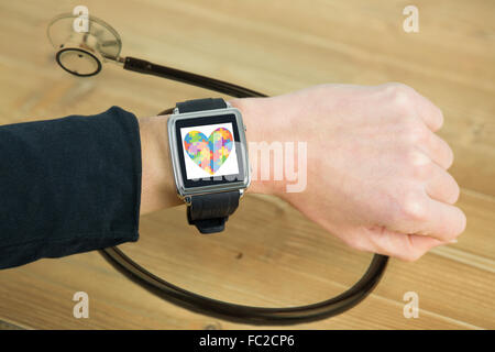 Composite image of businesswoman with smart watch on wrist Stock Photo
