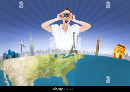 Composite image of shocked elegant businesswoman looking through binoculars Stock Photo