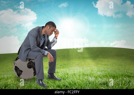Composite image of thinking businessman sitting Stock Photo