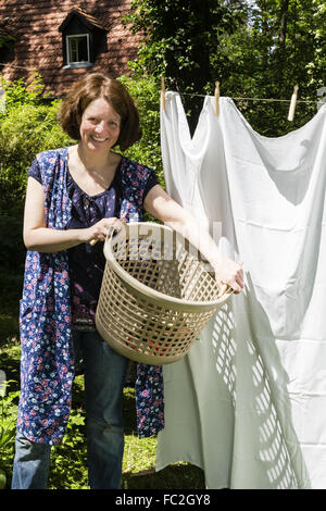 Hanging up the washing in a garden Stock Photo