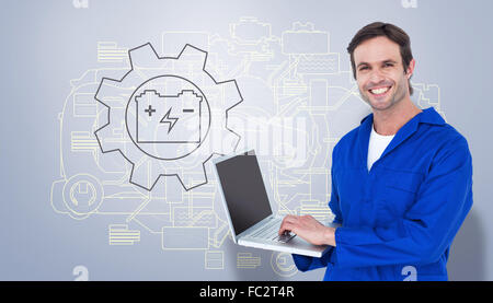 Composite image of handsome mechanic using laptop over white background Stock Photo