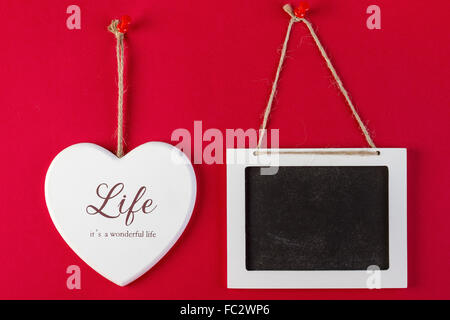 Love heart and empty blackboard on red texture background, Valentines day card concept. Stock Photo