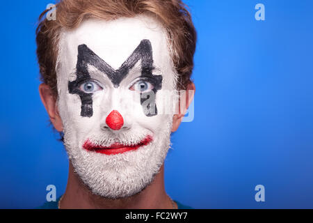 A man with clown makeup on his face Stock Photo