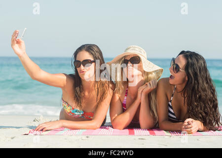 group of friends in swimsuits taking a selfie Stock Photo