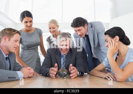 Businessman forecasting the future with his crystal ball Stock Photo