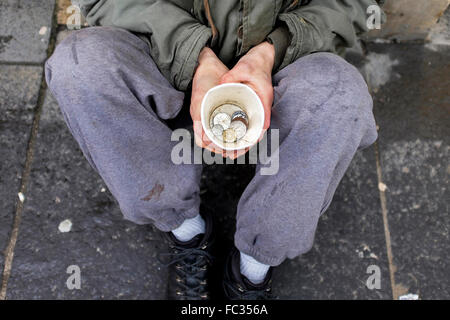 Glasgow, UK. 20th Jan, 2016. On the day when the UK Government released its official unemployment figures showing the lowest jobless total for 10 years, Matthew Murray, from Glasgow, spends his 10th year homeless and unemployed, begging on Sauchiehall Street, Glasgow.  Mr Murray, who is a qualified horticultural engineer, 10 years ago broke his back in an accident and subsequently lost his job. He now lives in homeless hostels in Glasgow city centre. Credit:  Findlay/Alamy Live News Stock Photo