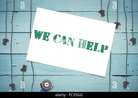 We can help against plugs on wooden background Stock Photo