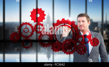 Composite image of focused businessman pointing with finger Stock Photo