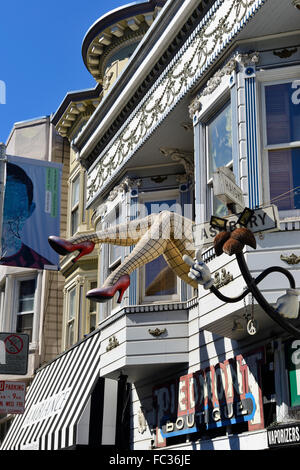 Giant legs leaning from window of gift store in Haight Ashbury district of San Francisco, California, USA Stock Photo